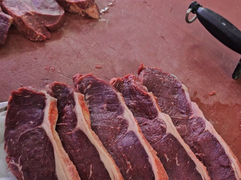 Steaks laid on butcher paper for packing at Ikhlas Halal Butcher, Bradford