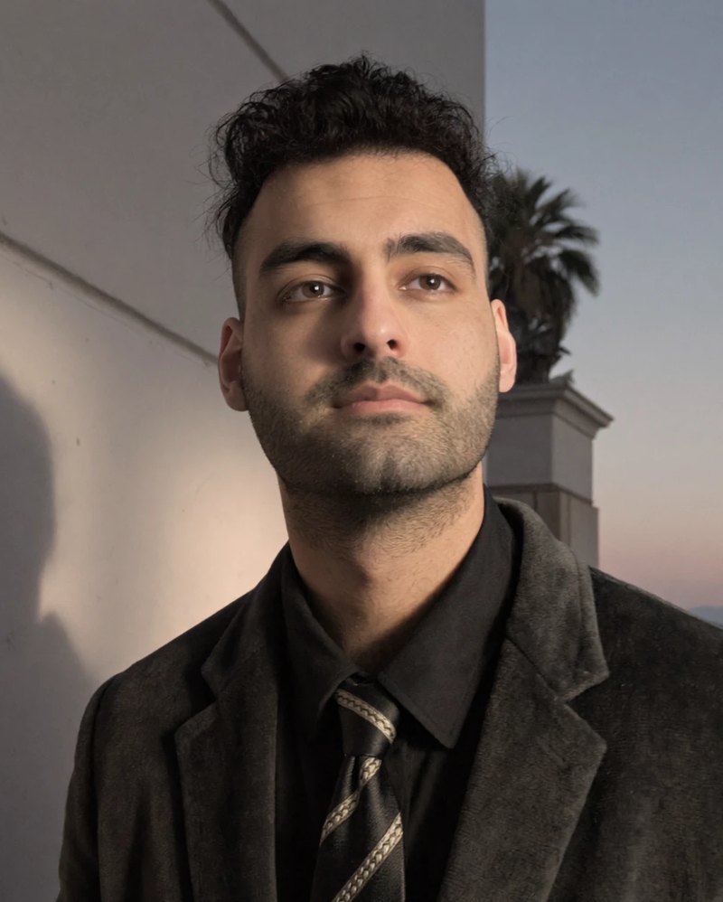 Adam Aziz of Veritas UI, Business Development Manager, in a dark jacket and tie
