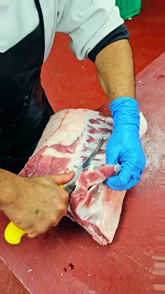 Trimming a rack of lamb at Ikhlas Halal Butcher
