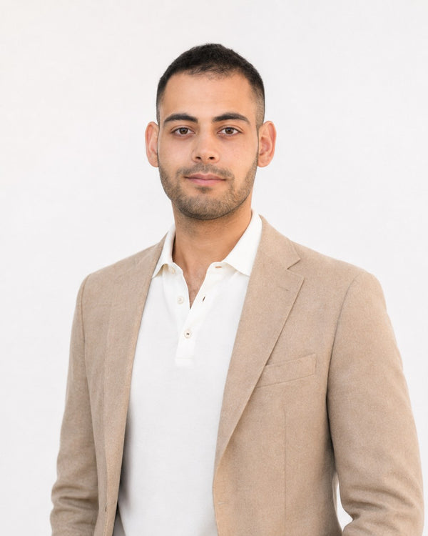 Amir Aziz, Social Media Manager at Veritas UI, in a beige jacket