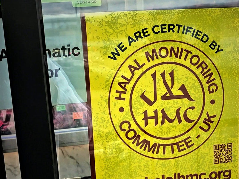 HMC halal certificate on the shop door of Ikhlas Halal Butcher, Bradford