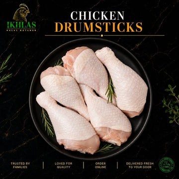 Raw halal chicken drumsticks on a white background, photographed for a butcher website