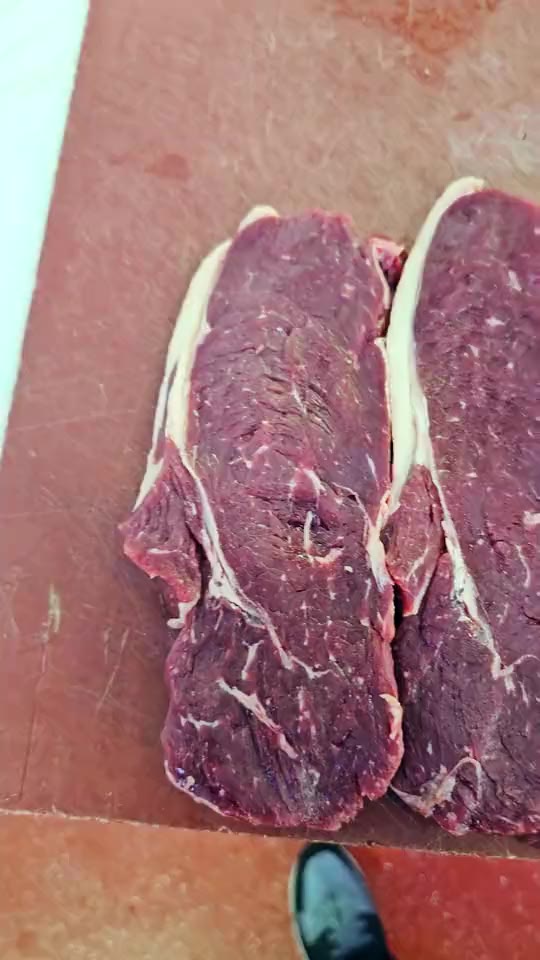Cutting steaks from the primal at Ikhlas Halal Butcher