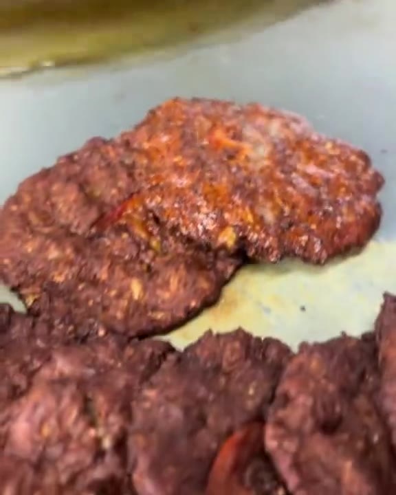 Close-up of grilled kebabs, a still from a social media reel